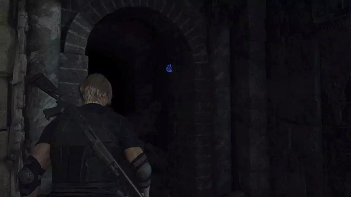 Leon looking at a blue medallion in the Cliffside Ruins.