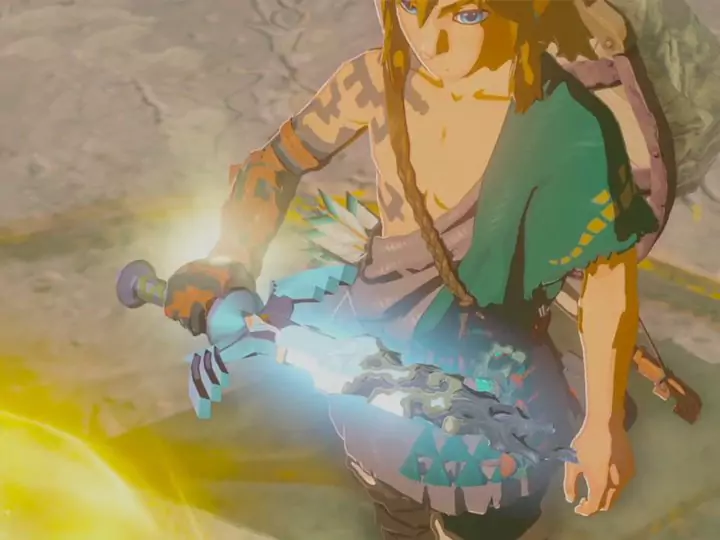 Link holding the broken Master Sword near a golden light in The Legend of Zelda: Tears of the Kingdom.