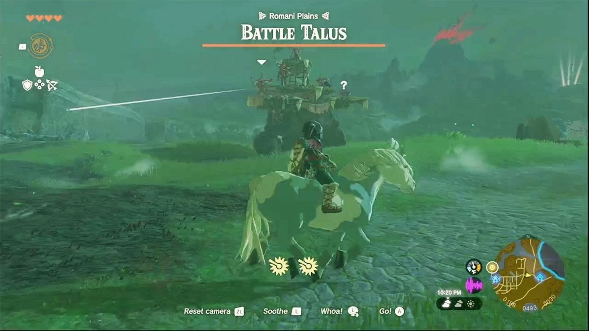 Link riding a horse and looking at a Battle Talus, which is a large, stone enemy in The Legend of Zelda: Tears of the Kingdom.