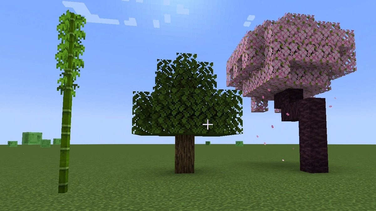 A Bamboo shoot, an Oak Tree, and a Cherry Tree growing beside each other in Minecraft.