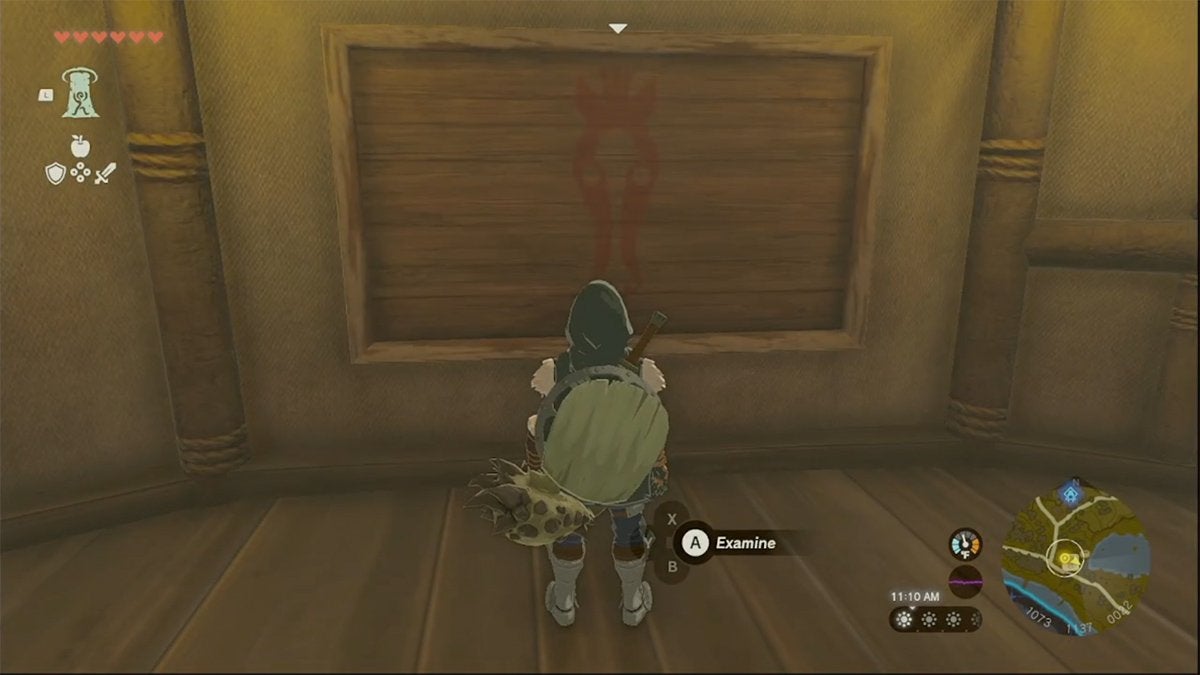 Link looking at the empty picture board in Woodland Stable.