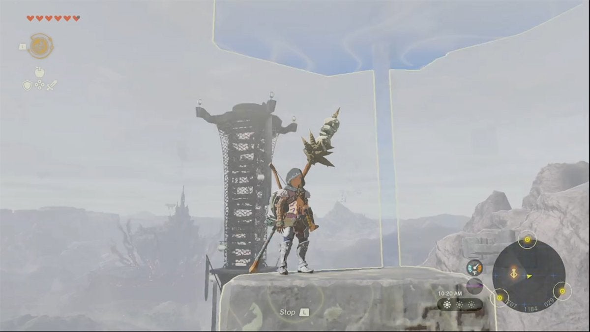 Link standing on an airborne rock that is rising due to the Recall ability. Link is near a Skyview Tower.