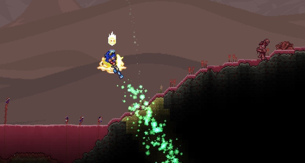 A Terraria player spraying the Clentaminator Green Solution to remove Crimson from their desert biome. 