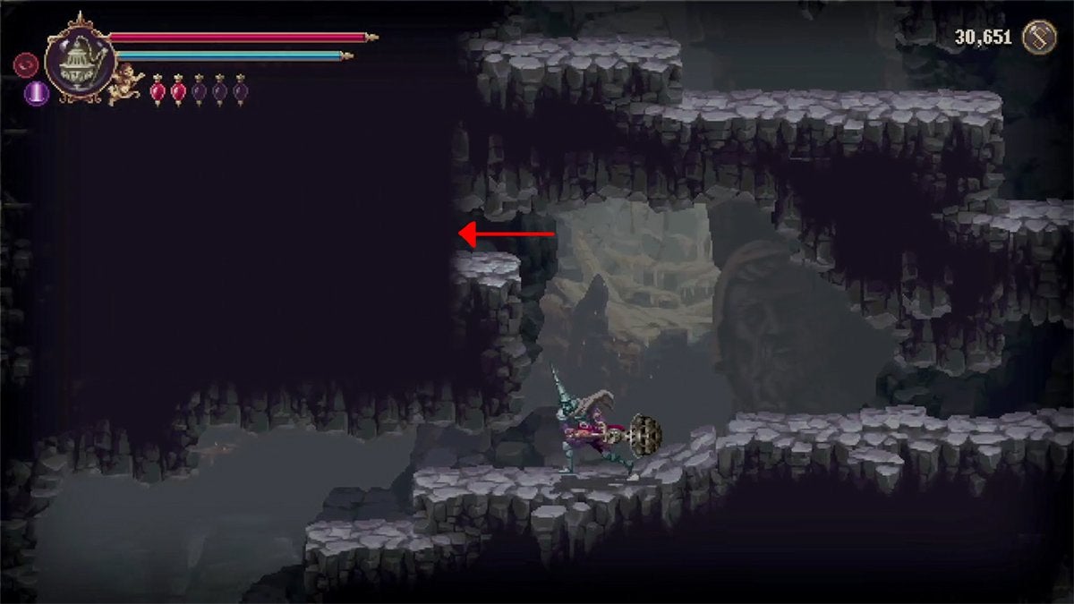 A red arrow pointing out the ledge leading to a hidden room.