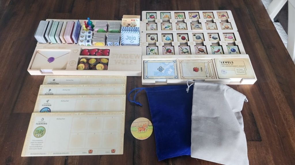The many components that come with the Stardew Valley board game.