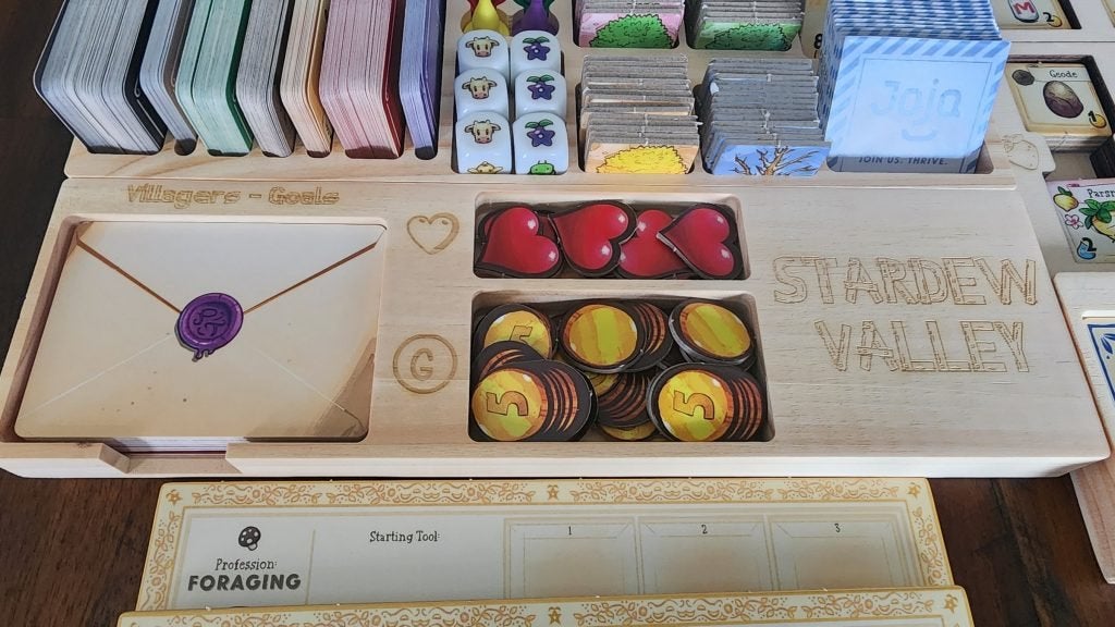 A wooden organizer for pieces of the Stardew Valley board game.