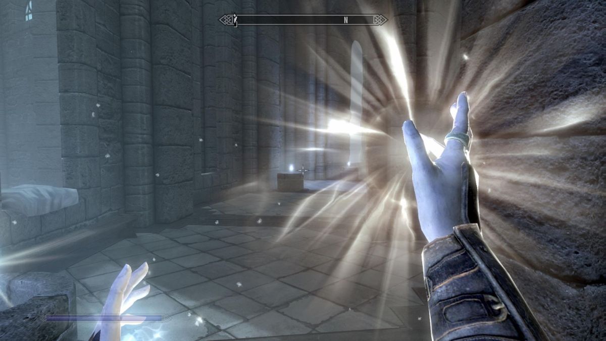 A Restoration healing spell being cast from a pair of hands in Skyrim.