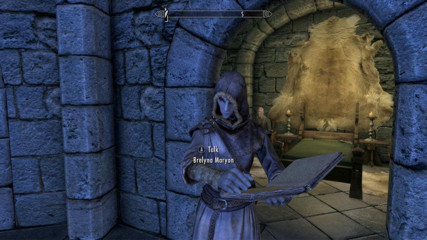 Brelyna Maryon from Skyrim reading a book inside the College of Winterhold