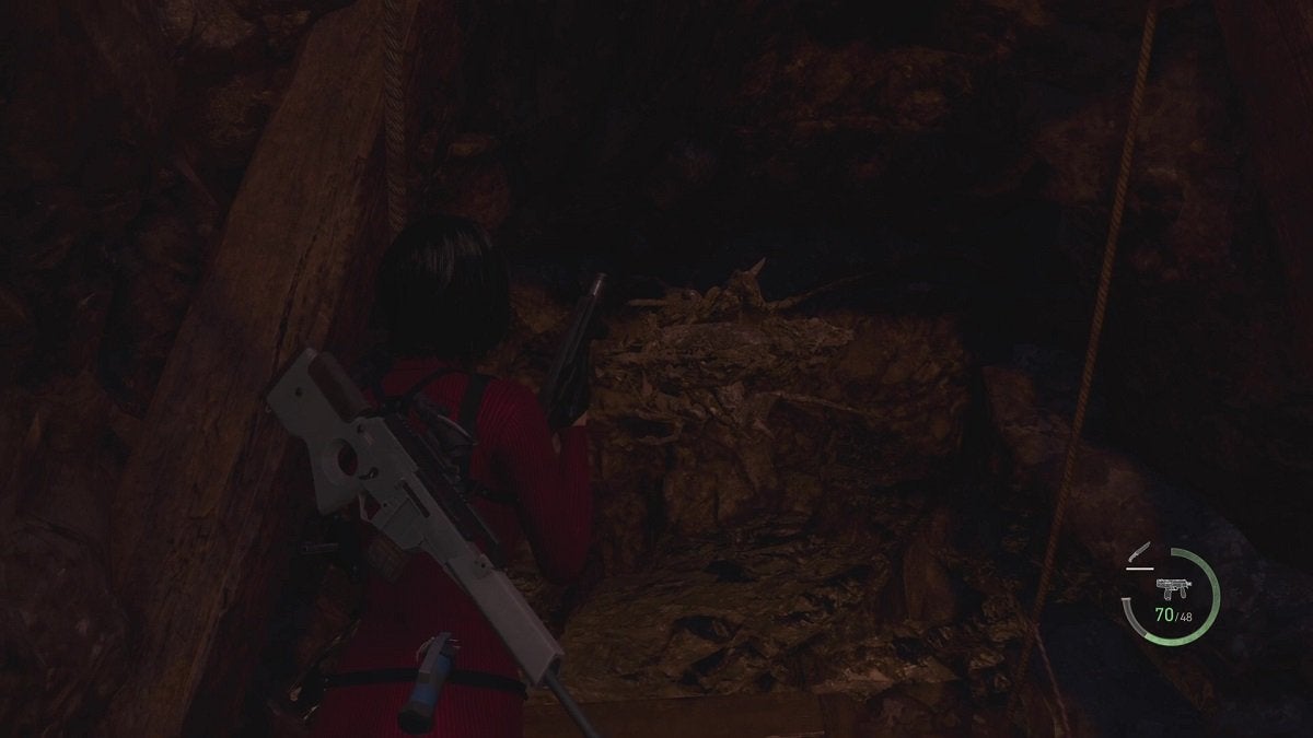 Ada looking at a camouflaged Novistador near a wooden beam in a dark cave.