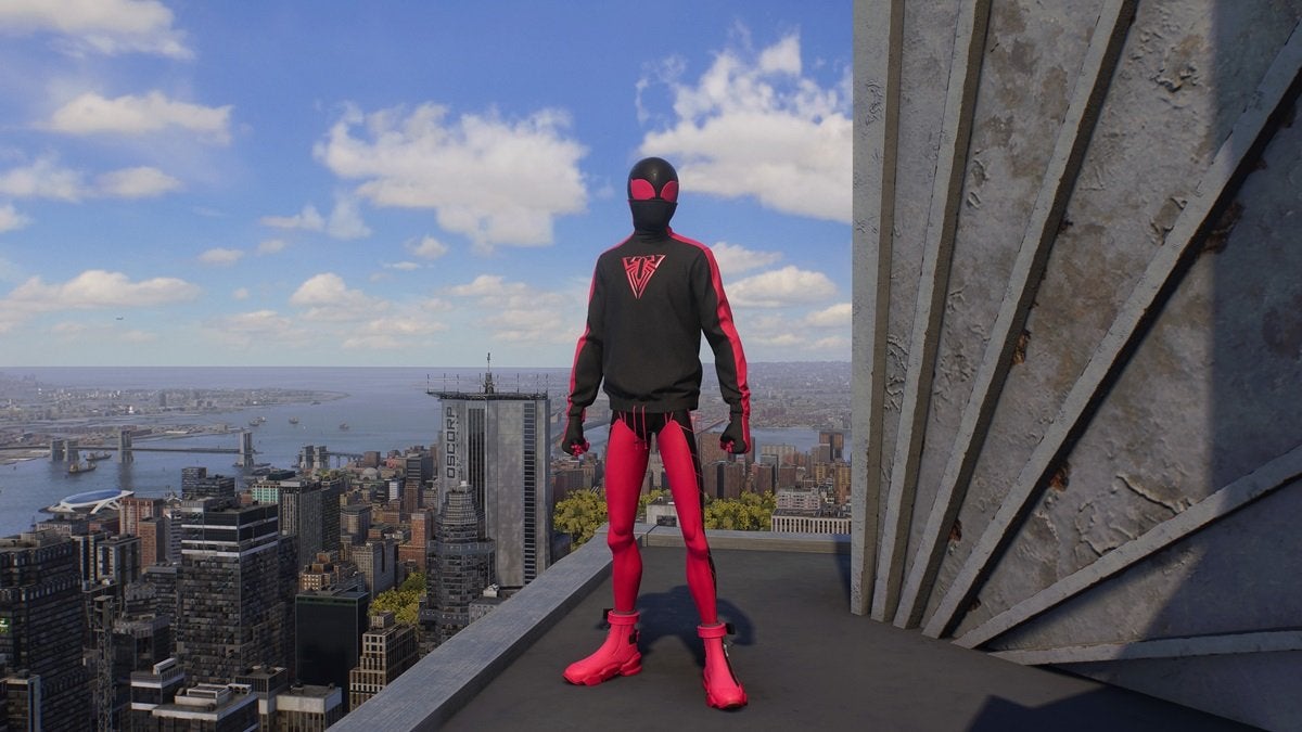 Miles Morales wearing the 10th Anniversary Suit, which is light red and black. The top looks like a sweater featuring a triangular red spider on the chest.