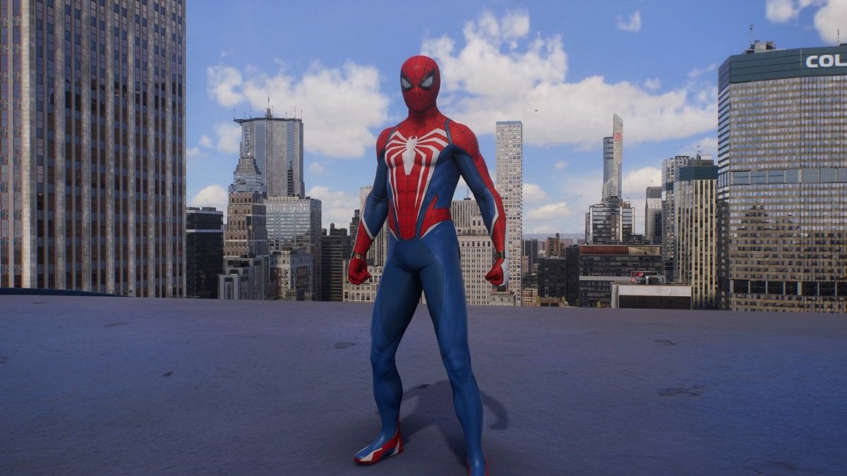 Peter Parker wearing the Advanced Suit 2.0, which is red, white, and blue with a white spider on the chest.