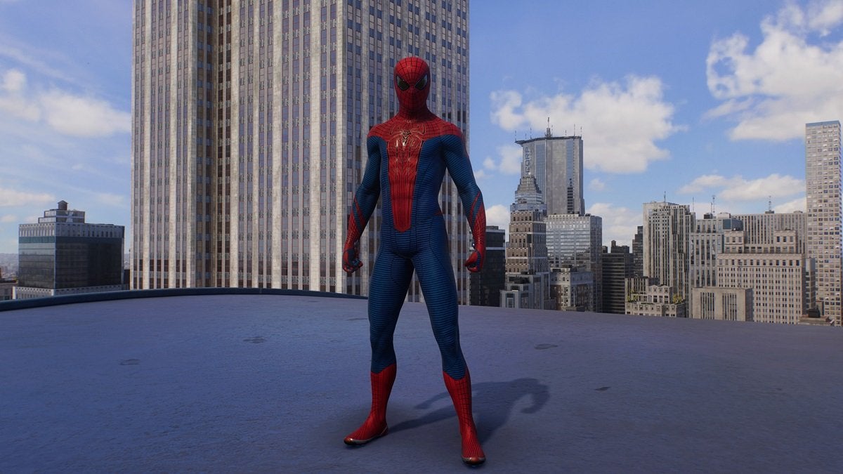 Peter Parker wearing the Amazing Suit, which is red and blue with a small black spider on the chest and black eye pieces.
