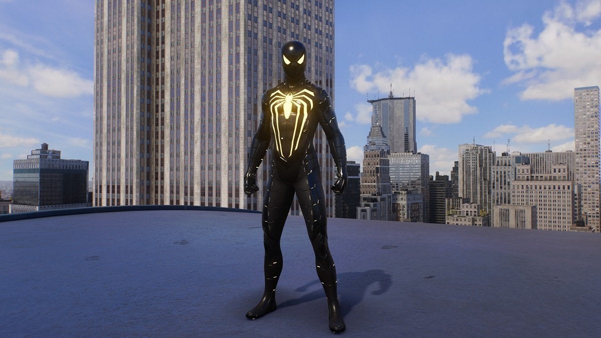 Peter Parker wearing the Anti-Ock Suit, which is all black with a large glowing yellow spider on the chest and bright yellow eye pieces.