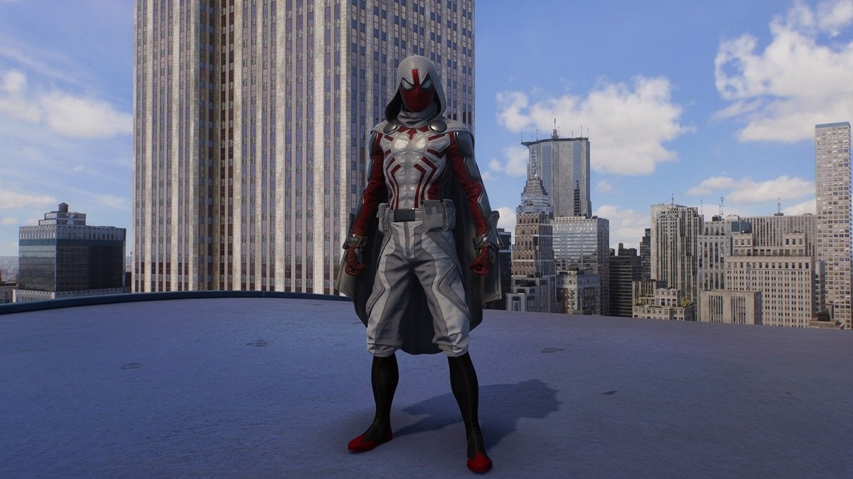 Peter Parker wearing the Arachknight Suit, which is gray and red with a cape and a hood.