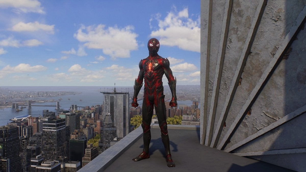 Miles Morales wearing the Biomechanical Suit, which is red and black with a glowing orange spider on the chest. This suit looks like its made from large, jagged scales.