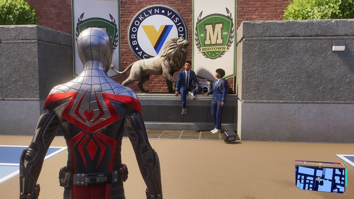 Miles Morales at Brooklyn Visions. He's looking at a statue of a lion near to two students in school uniforms.