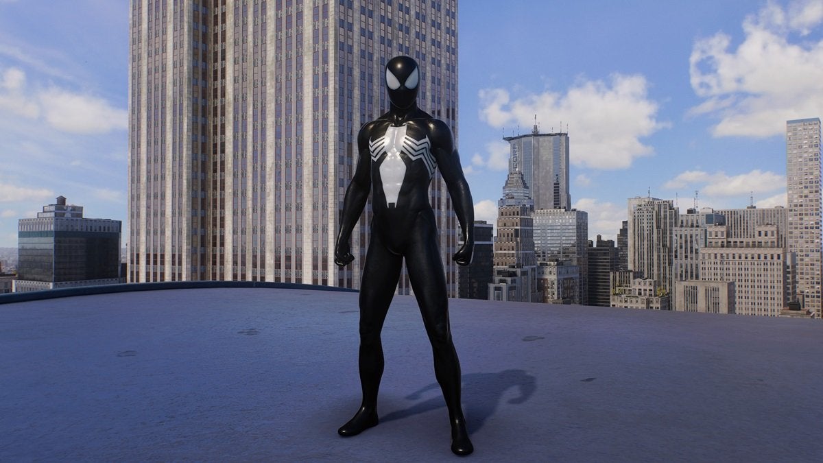 Peter Parker wearing the Classic Black Suit, which is all black with a large white spider on the chest.