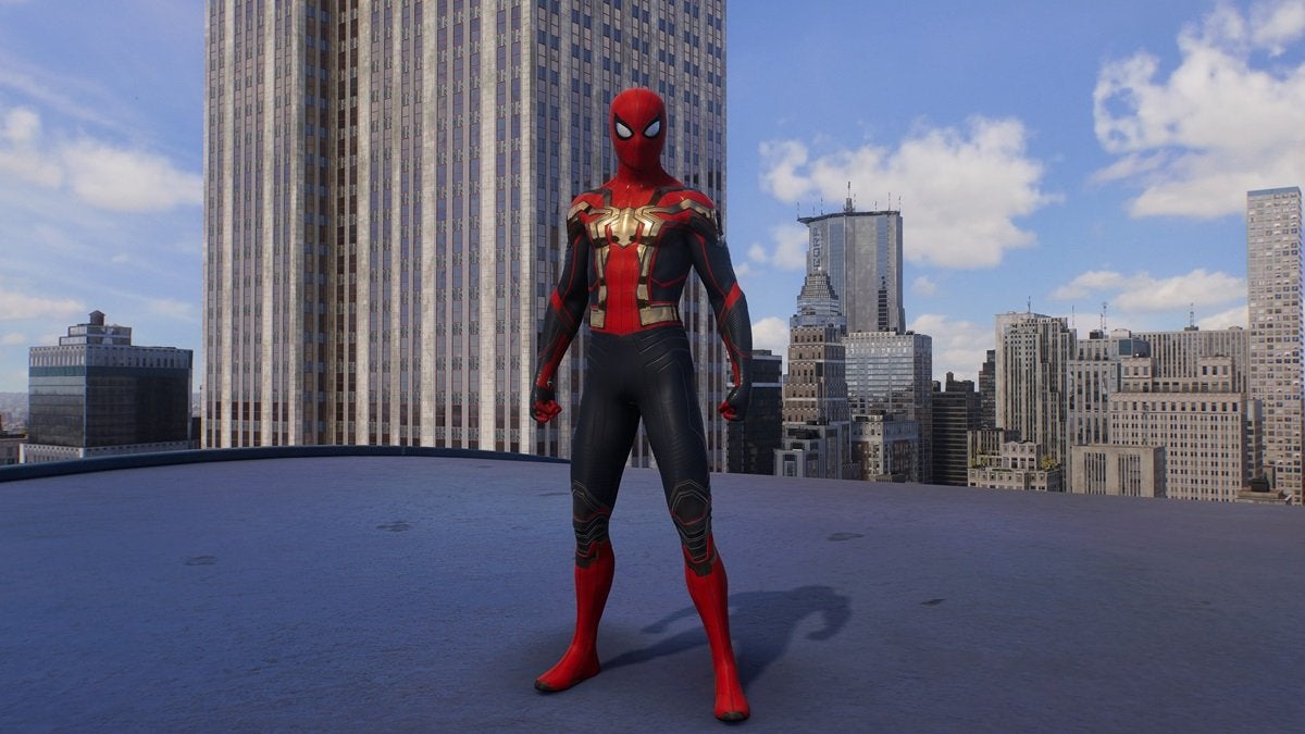 Peter Parker wearing the Hybrid Suit, which is red and black with a golden spider on the chest.