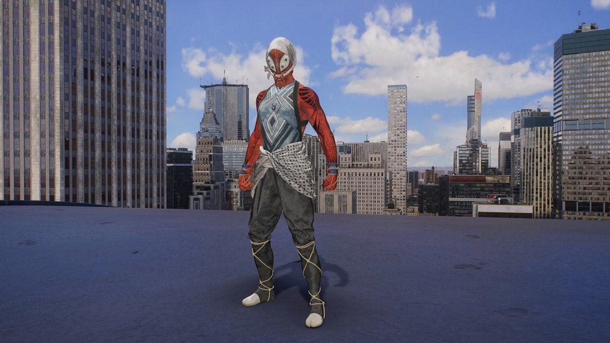 Peter Parker wearing the Kumo Suit, which is white, orange, and gray with a ninja-like design.