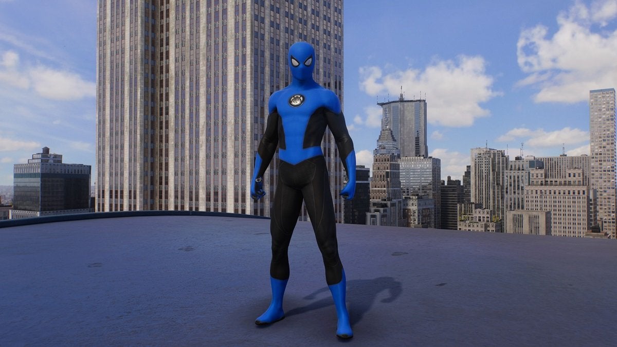 Peter Parker wearing the New Blue Suit, which is blue and black with a small black and white spider on the chest in the shape of a circle.