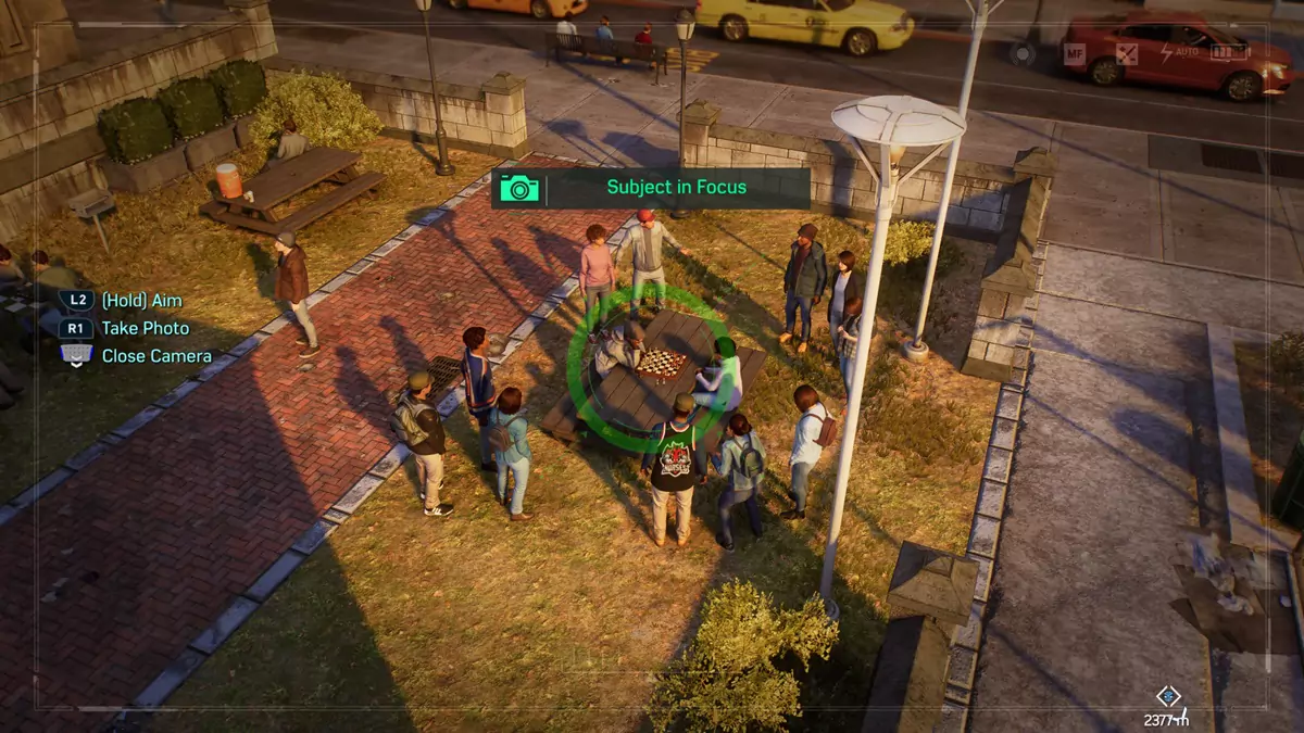 The player taking pictures of citizens of New York within a small park in Spider-Man 2.
