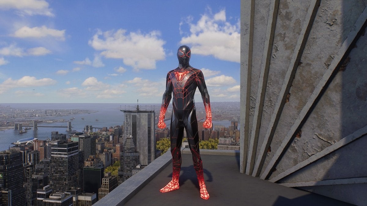 Miles Morales wearing the Programmable Matter Suit, which is black, gray, and red. The chest, hands, and feet of the suit are glowing with red and white light.