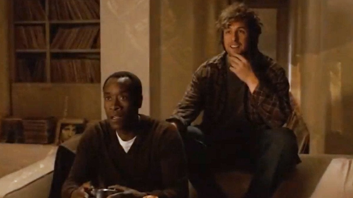 Adam Sandler and Don Cheadle sitting next to each other in the movie "Reign Over Me."