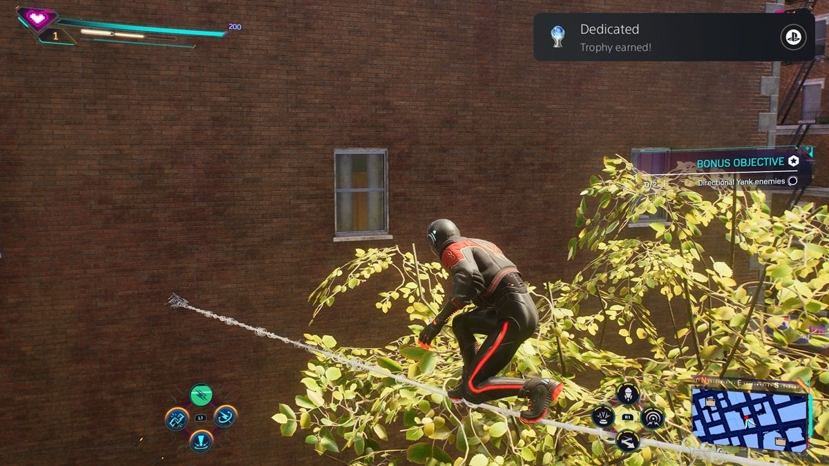 The player earning the Dedicated Platinum Trophy in Spider-Man 2 while Spider-Man is walking across a rope made of webs.