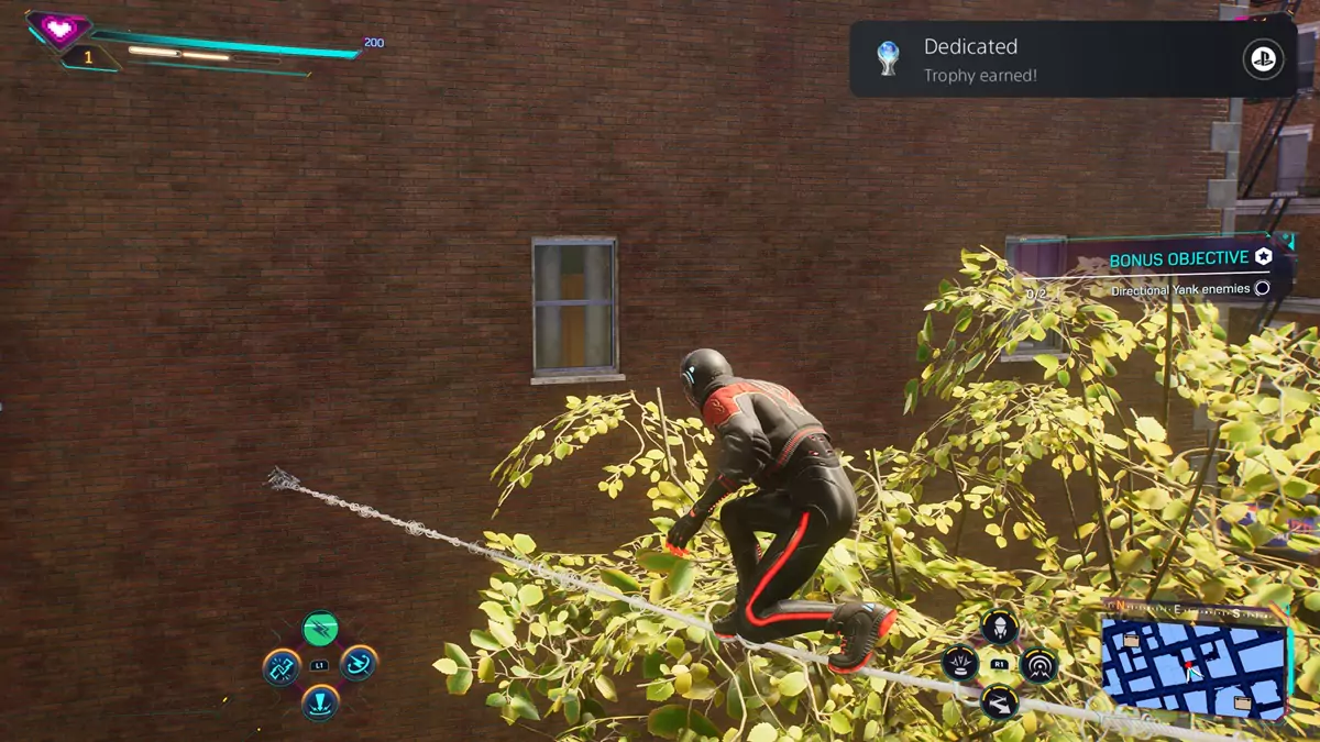 The player earning the Dedicated Platinum Trophy in Spider-Man 2 while Spider-Man is walking across a rope made of webs.