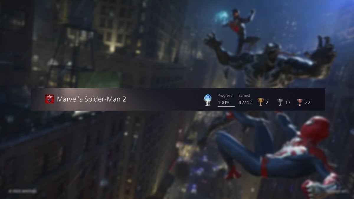 The Platinum trophy for Spider-Man 2 in front of a background depicting Spider-Man swinging through a city.