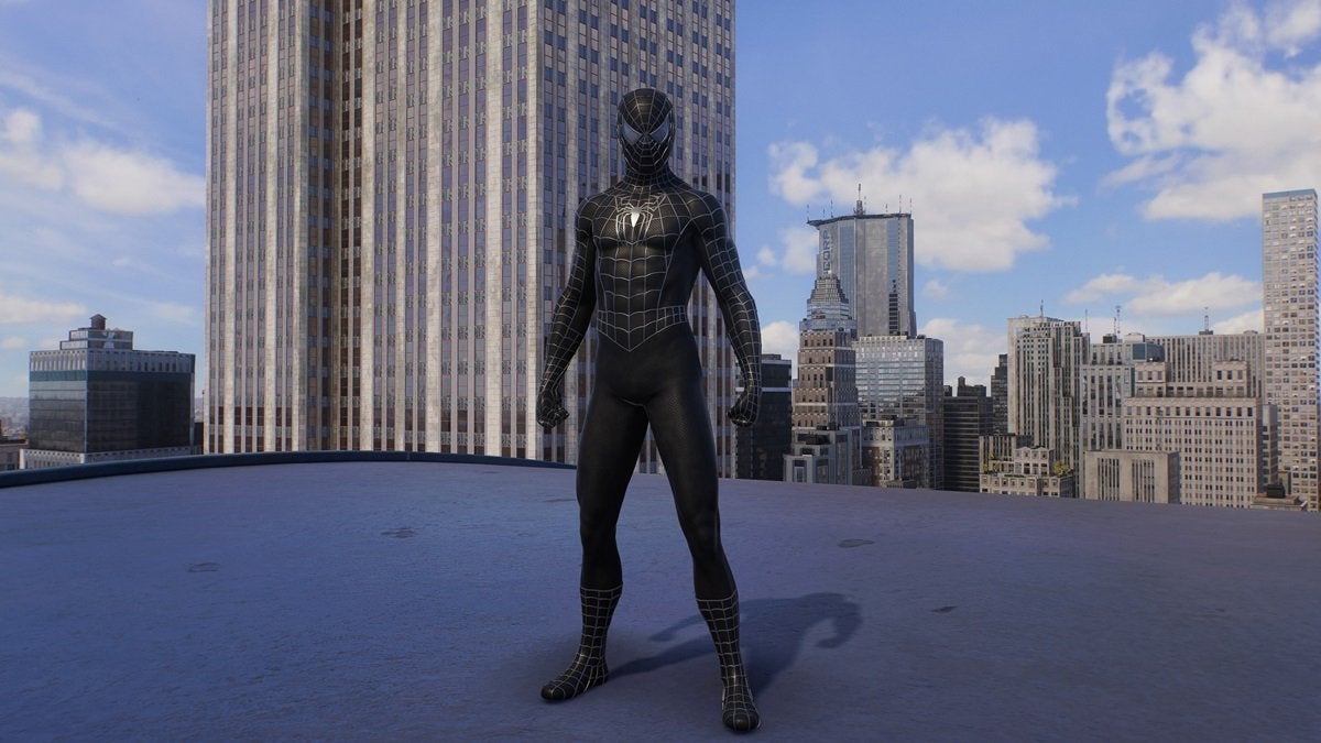 Peter Parker wearing the Webbed Black Suit, which is all black and has a small gray spider on the chest.