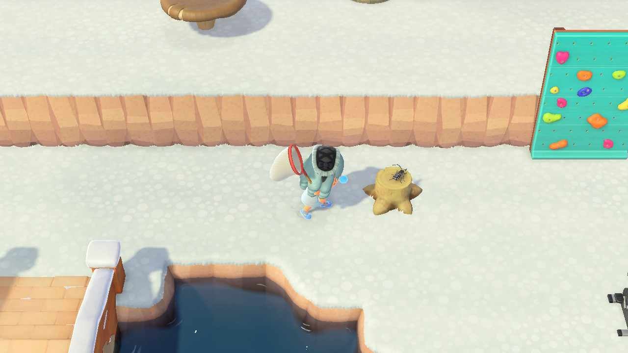 An Animal Crossing: New Horizons player attempting to catch a beetle on a tree stump. 
