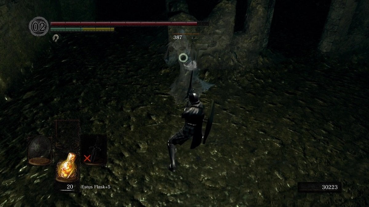 The Chosen Undead attacking a ghost with a cursed weapon in Dark Souls.