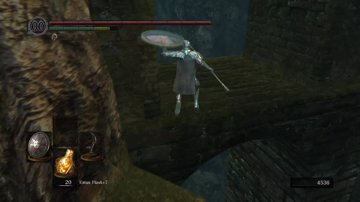 The Chosen Undead jumping towards the area under the aqueduct in Firelink Shrine.