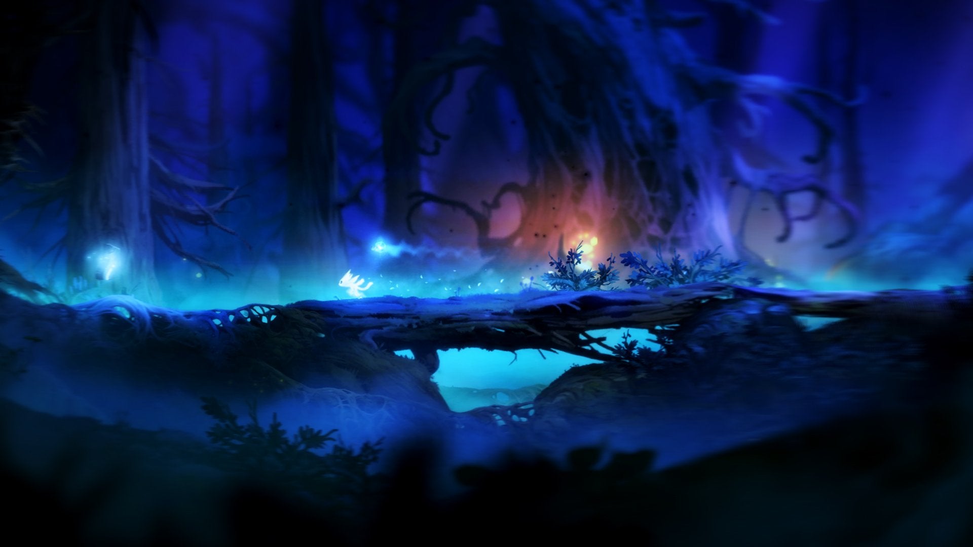 The player running across a log at night in Ori and the Blind Forest.