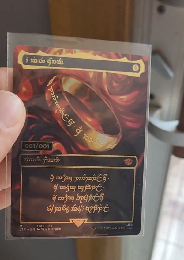 Brook Trafton holding the 1:1 The One Ring MTG card.