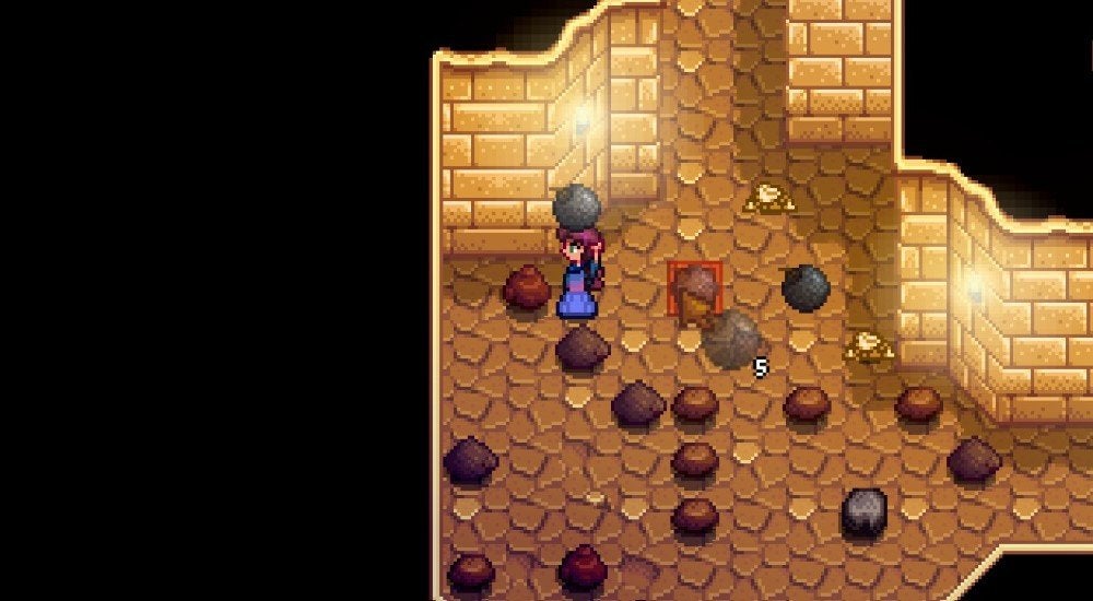 A player holding a bomb over their head in the Skull Cavern of Stardew Valley. They are about to throw the bomb at a couple of downed Mummies.