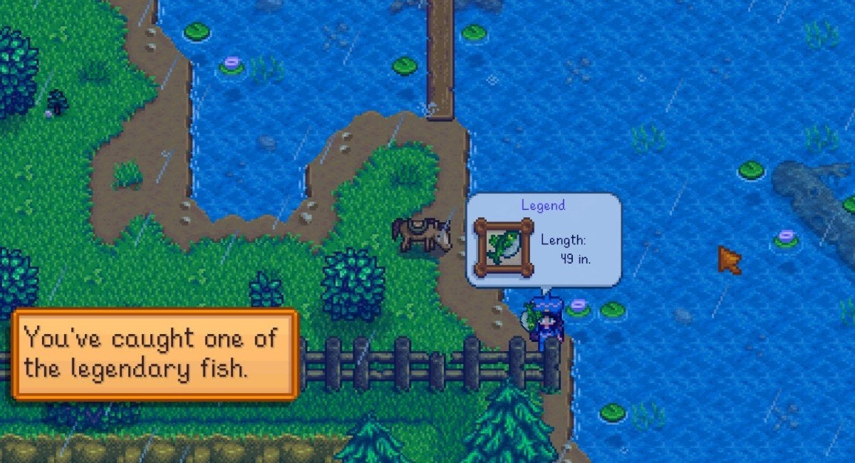 The player holding the fat green Legend fish above their head after catching it in Stardew Valley.