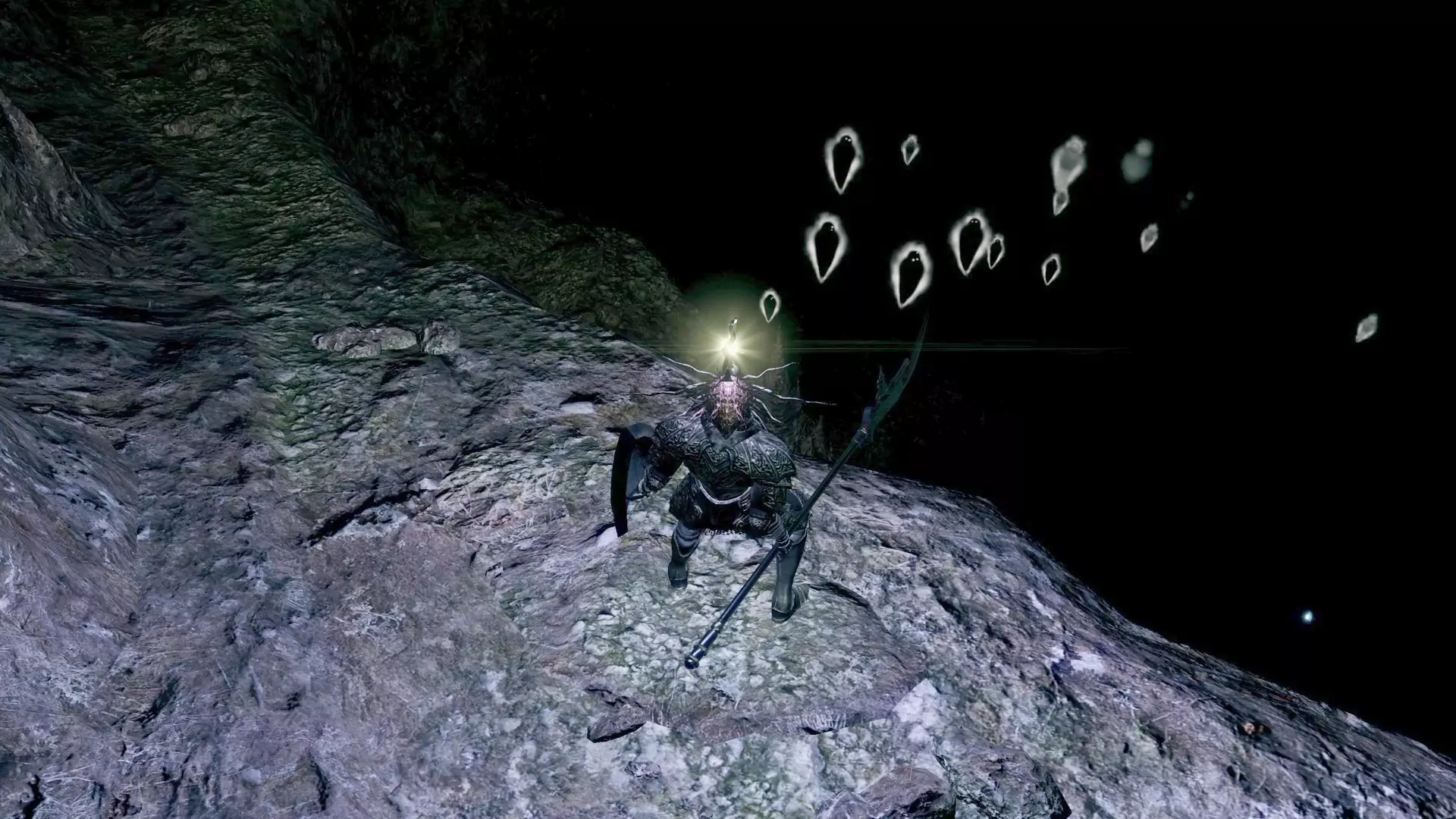 The Chosen Undead at the Chasm of the Abyss, overlooking a group of Humanity Spirits.