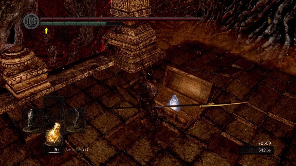 The Chosen Undead standing before the chest that holds the Large Flame Ember in Dark Souls.
