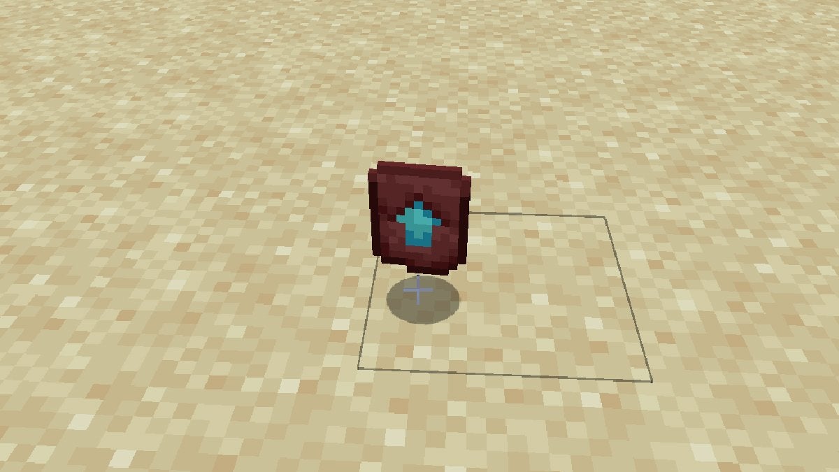 A Netherite Upgrade Smithing Template on a sandy beach in Minecraft.