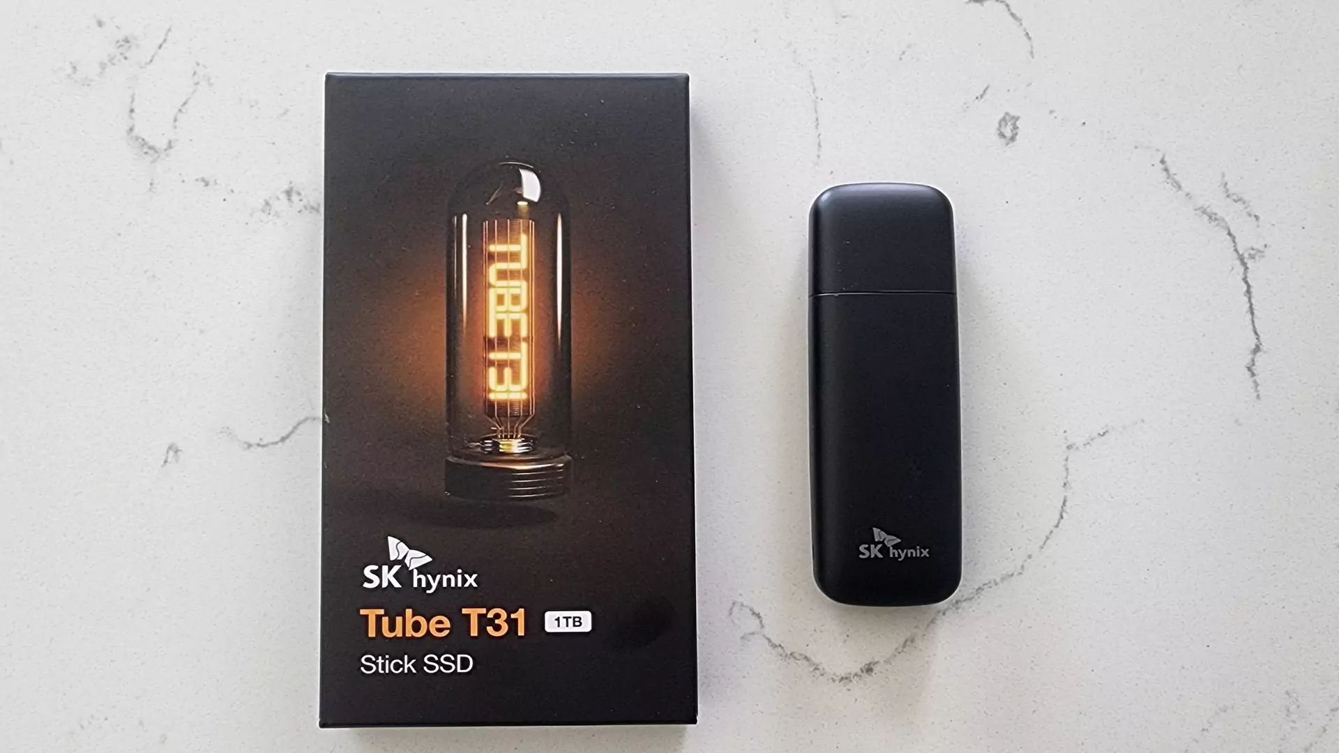 The 1TB model of the SK Hynix Tube T31 Stick SSD beside its box.