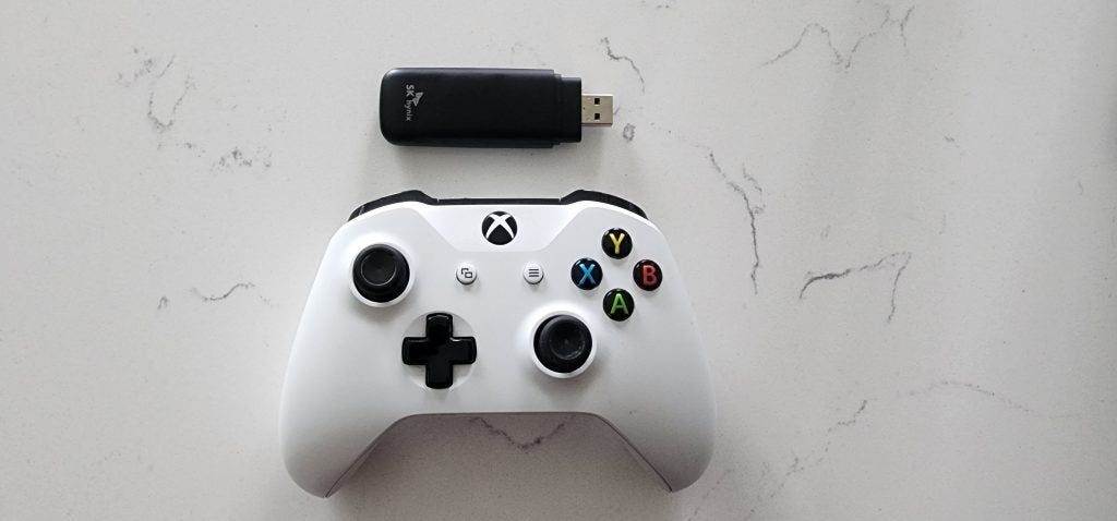The SK Hynix Tube T31 Stick SSD next to a standard Xbox controller. 
