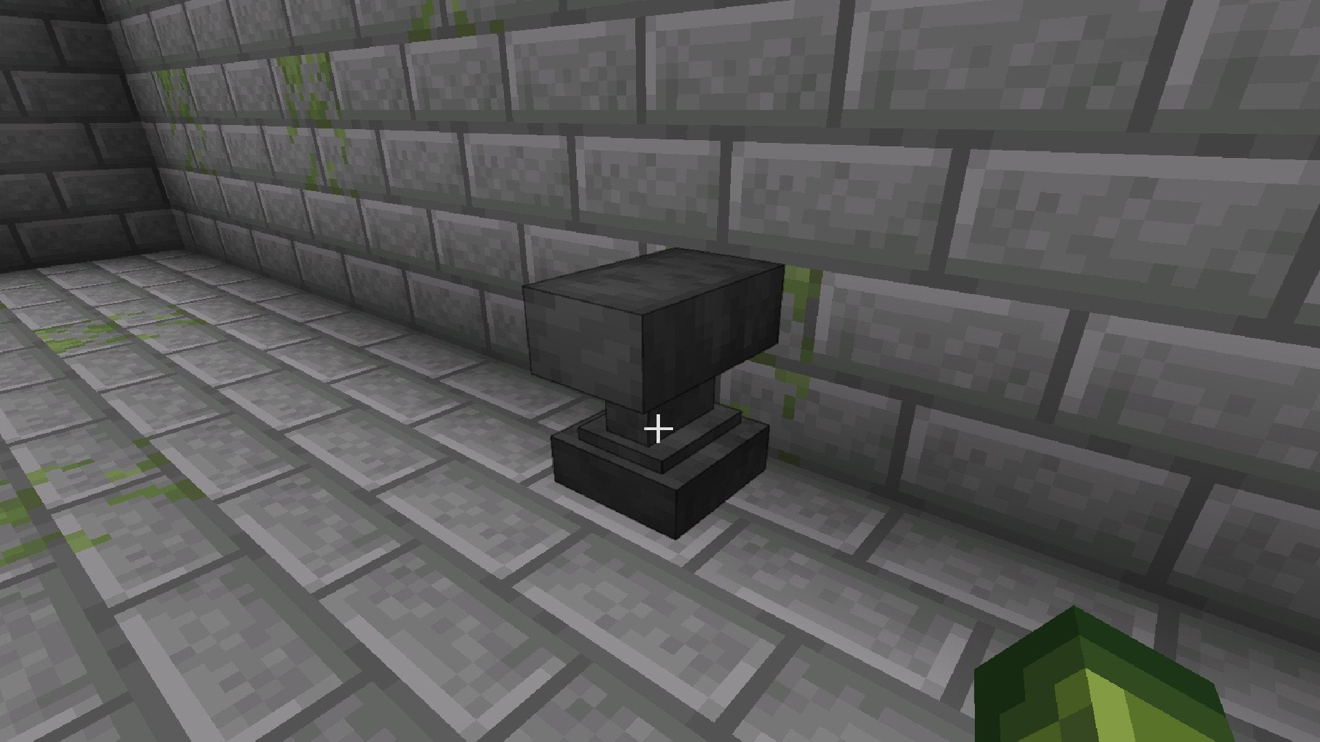 An Anvil in a room made of Stone Bricks in Minecraft.