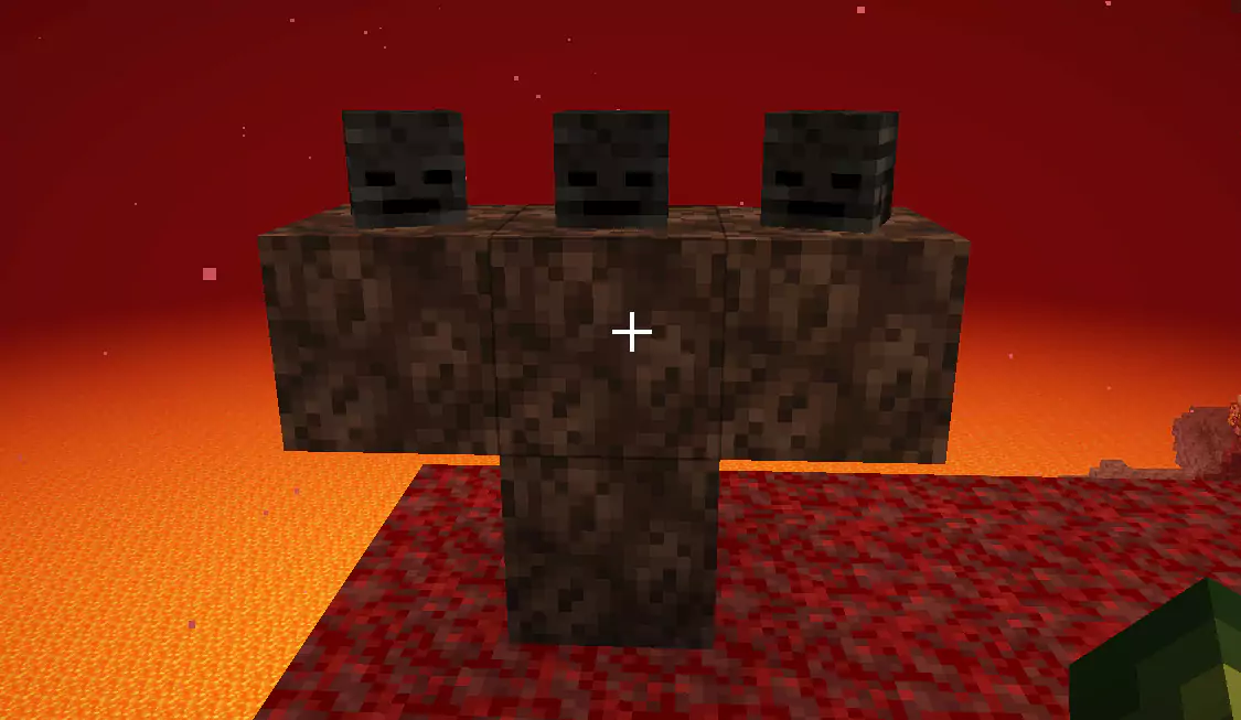 A T-shaped statue of Soul Sand with three Wither Skeleton Skulls on top of it.